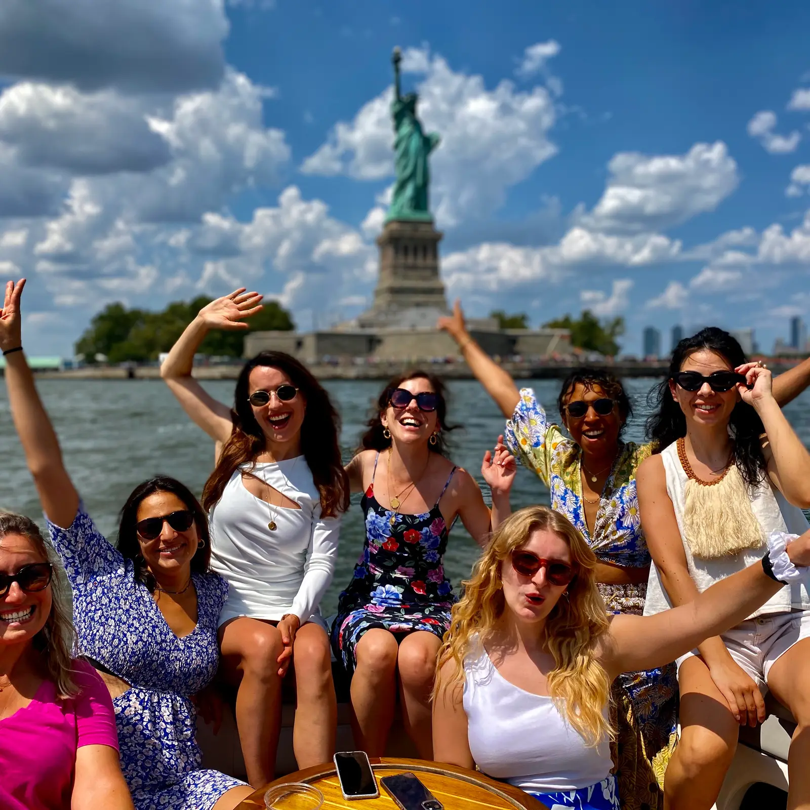 A group photo in front of the Statue of Liberty during a New York Charters tour