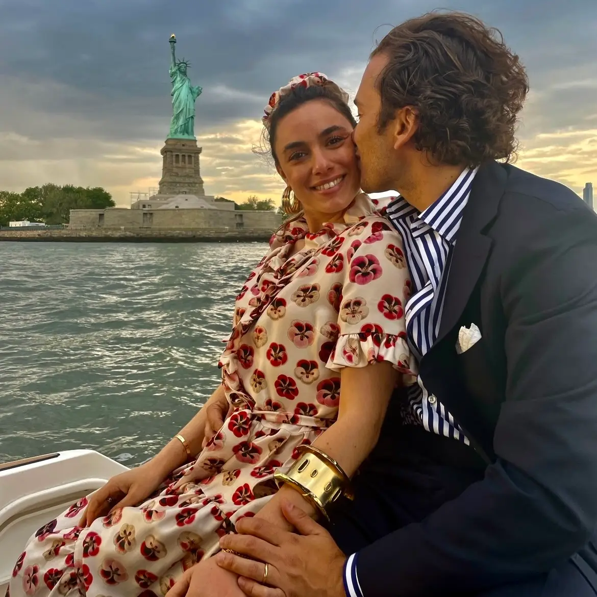 A couple enjoying a romantic moment on the water near the Statue of Liberty