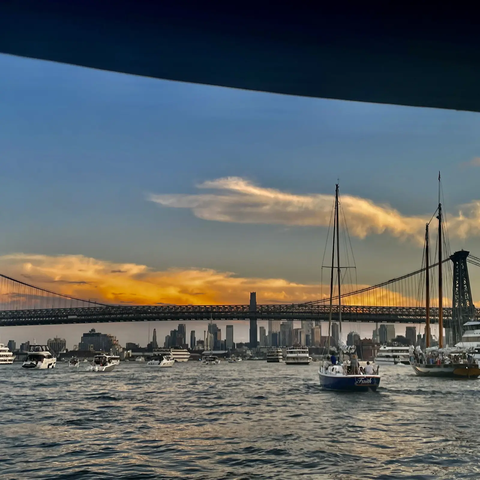 Friends watching the sunset over the NYC bridges from the charter boat