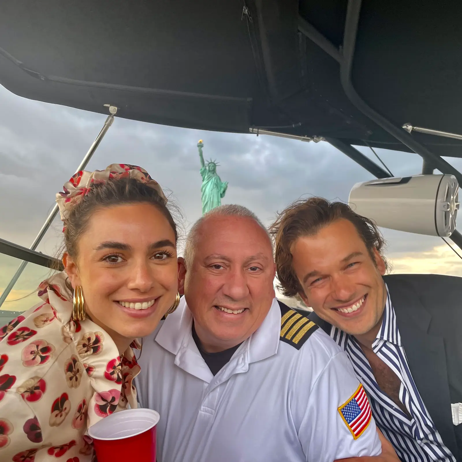 Friends celebrating on a New York Charters trip with the Brooklyn Bridge in view