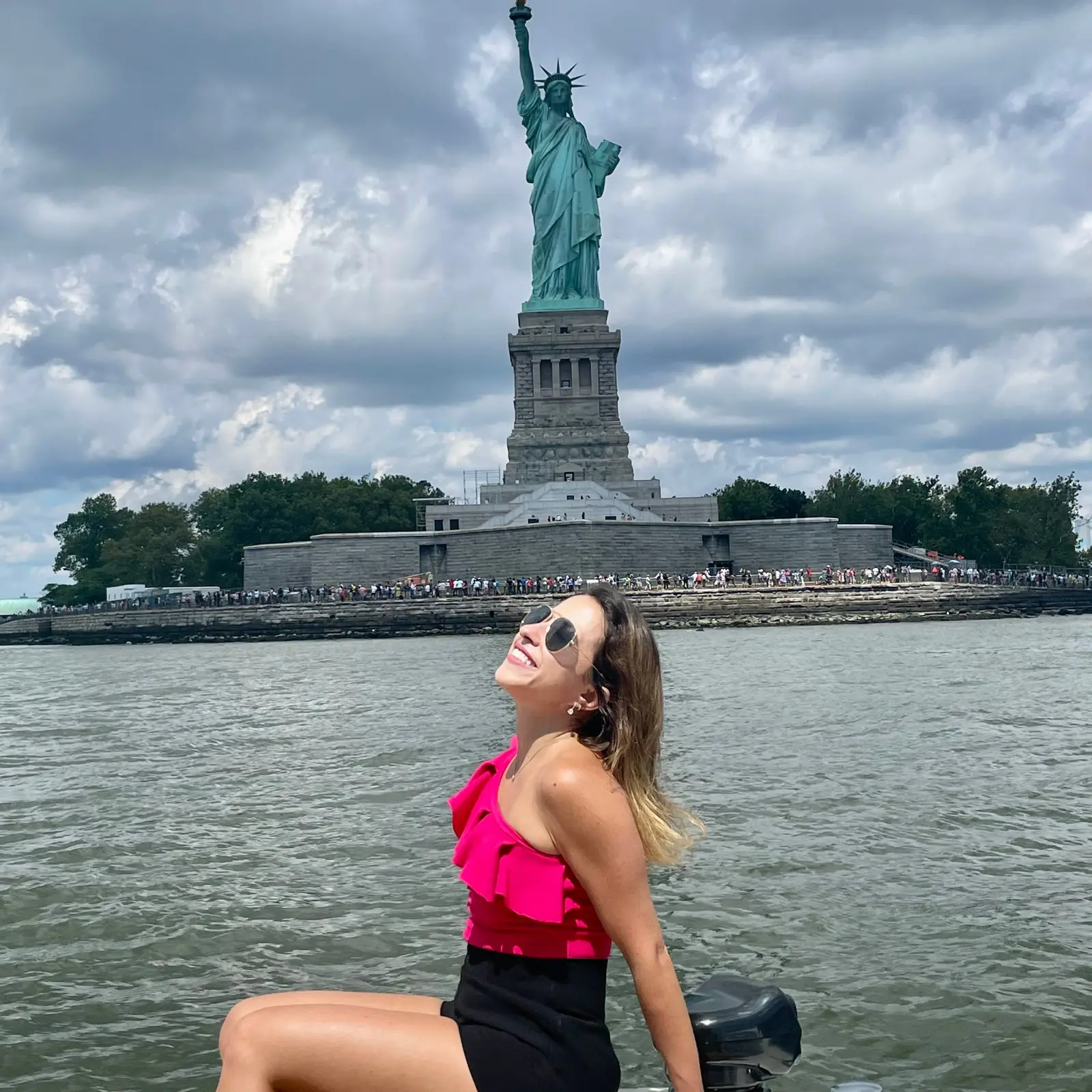 A guest enjoying a quiet moment near the Statue of Liberty on a New York Charters trip